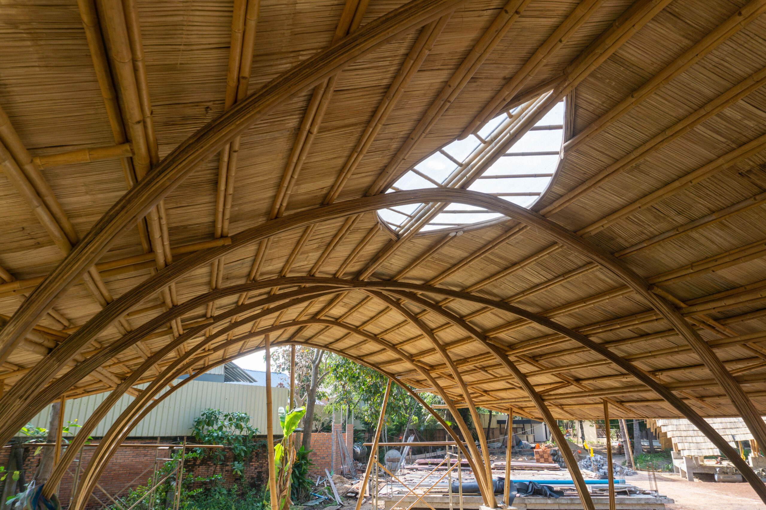 The photo of bamboo curved roof with skylight from inside perspective