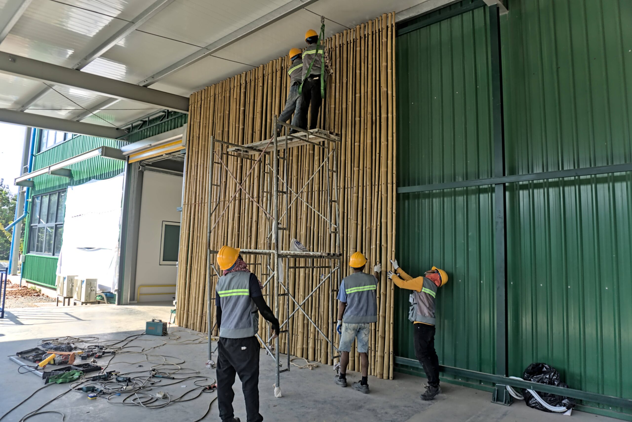 The photo of installation of vertical bamboo panels on a wall