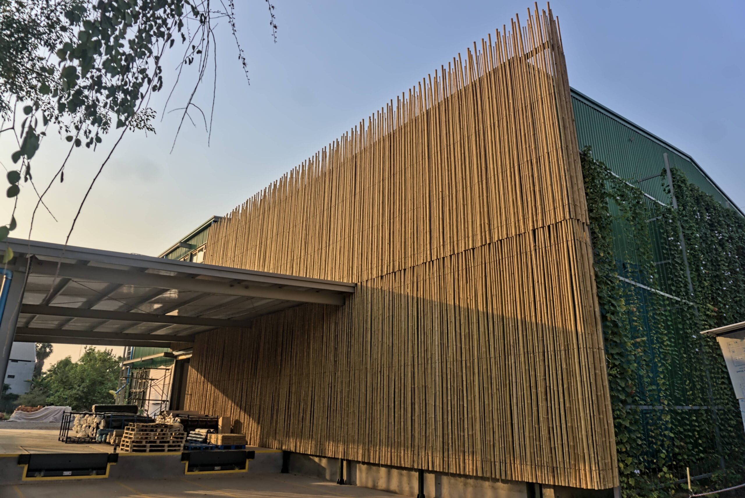 The photo of massive external bamboo wall for Warehouse Building